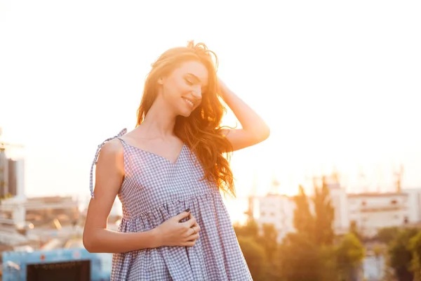 Attractive Smiling Ginger girl in dress posing with closed eyes — Stock Photo, Image