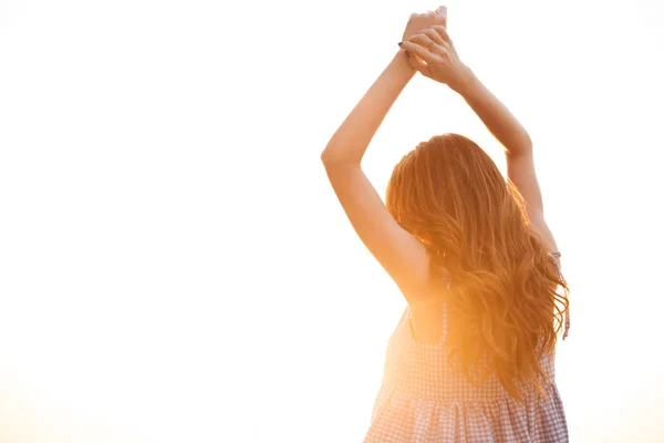 Back view of ginger woman in dress posing on sunset — Stock Photo, Image