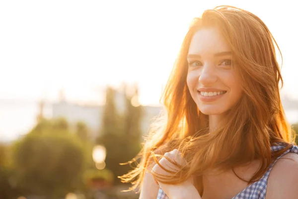 Smiling young redhead girl with long hair — Stock Photo, Image