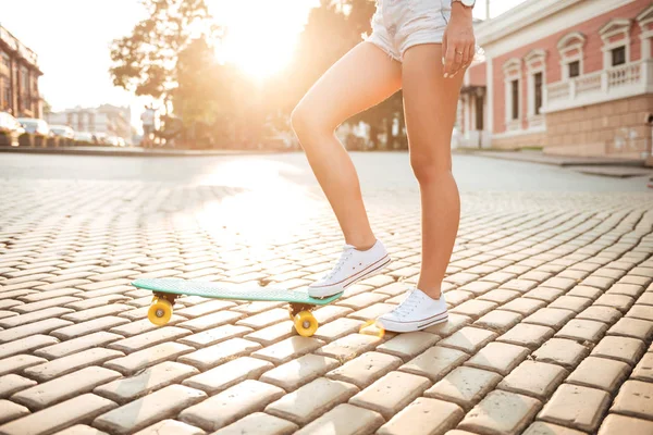 Περικομμένη εικόνα της νεαρής γυναίκας με skateboard — Φωτογραφία Αρχείου