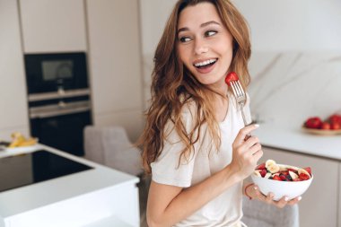 Gülümseyen kadın mutfakta dururken bir kenara arıyorsunuz