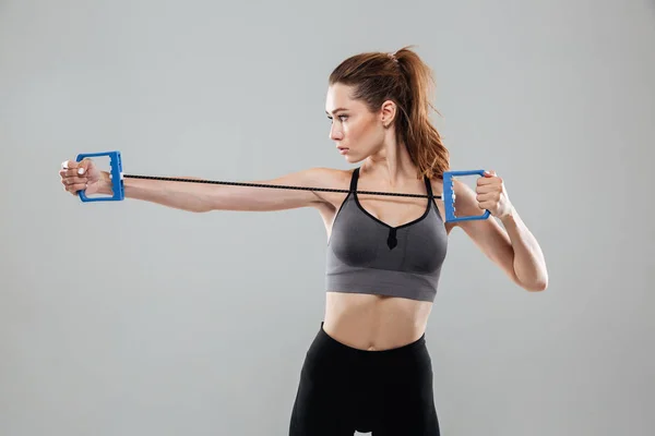 Side view of a sports woman doing exercises — Stock Photo, Image