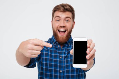 Mutlu sakallı adam boş smartphone ekran gösterilen Kareli gömlekli