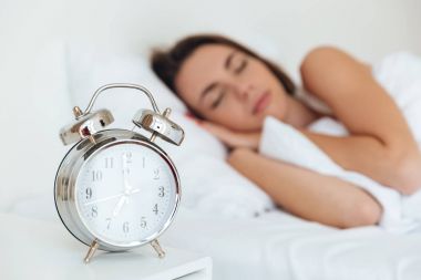 Bir çalar saat ile uyuyan kadın portresi kapatın