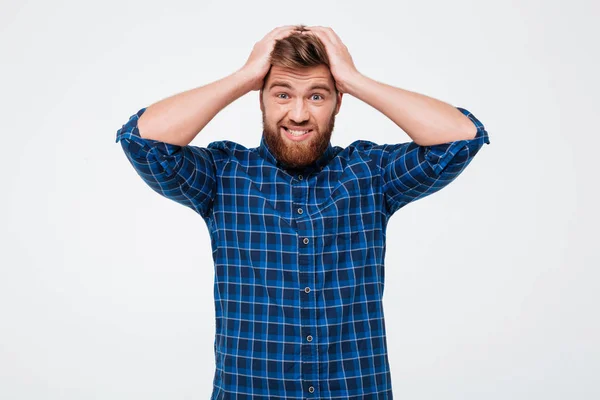Confused man holding his head and looking camera isolated — Stock Photo, Image