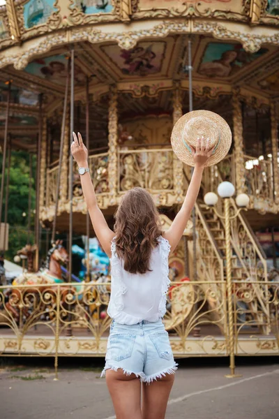 Back view portrait of a girl standing with outstretched hands — Stock Photo, Image