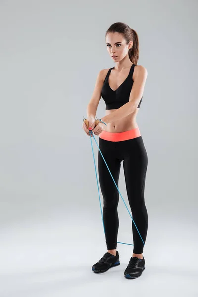 Imagen completa de una mujer seria haciendo ejercicio — Foto de Stock