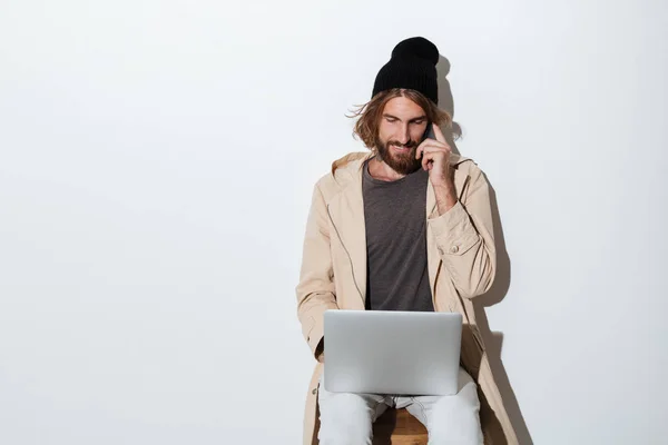 Hipster man looking aside with laptop computer — Stock Photo, Image