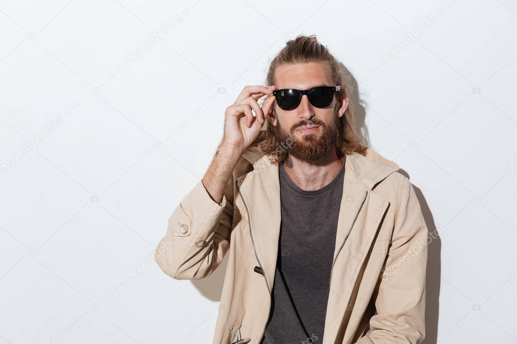 Hipster man looking camera isolated over wall background.