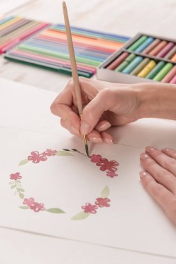 Genç sanatçı suluboya boya ve fırça ile desen çizimi