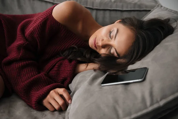 Close up of a beautiful asian woman in sweater sleeping