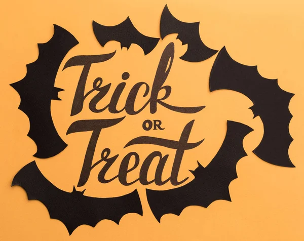 Logo de Halloween y murciélagos negros pintados sobre fondo naranja —  Fotos de Stock