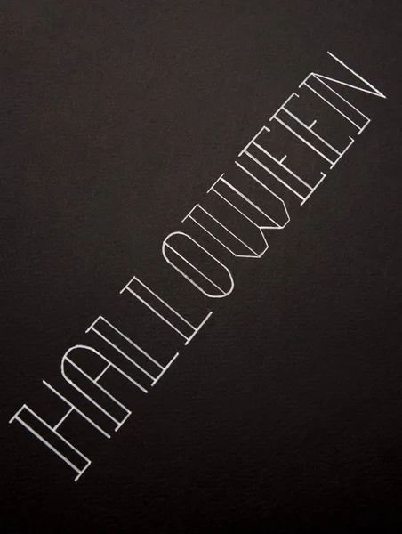 Текст шрифта для логотипа Хэллоуина, написанный от руки на черном фоне , — стоковое фото