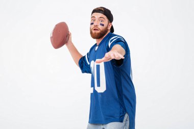 Yakışıklı adam tribünleri dolduran mavi t-shirt ragbi topu tutan.