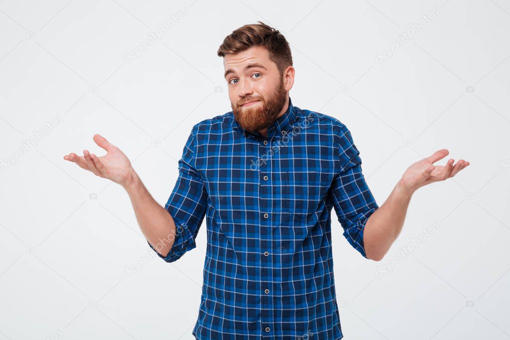 Confused young bearded man standing