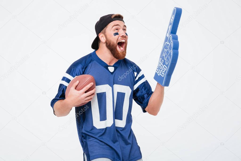 Screaming man fan in blue t-shirt standing isolated