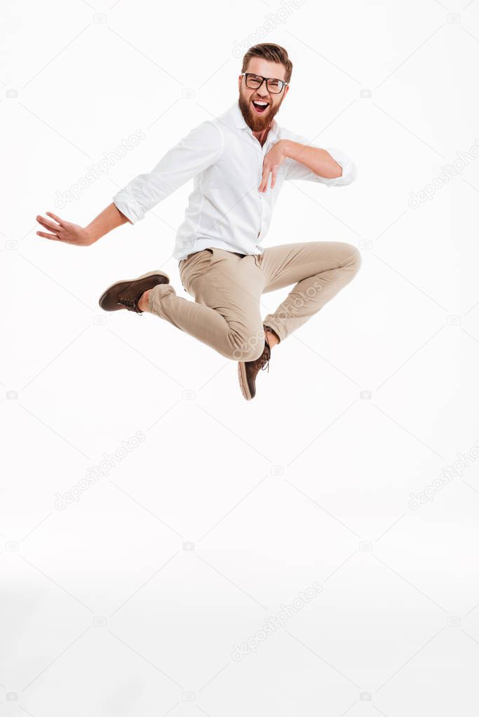 Cheerful young bearded man jumping.