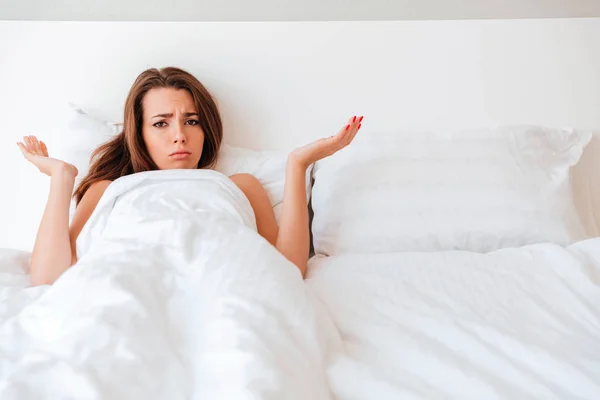 Frustrated upset woman lying in her empty bed — Stock Photo, Image