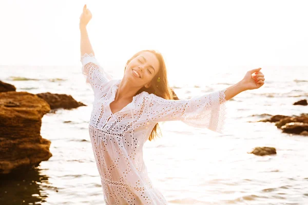 Image of pleased brunette woman in light summer dress — Stock Photo, Image