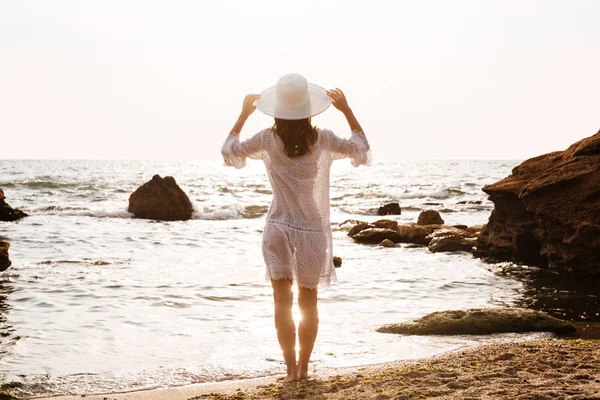 Back view of woman in hat and light summer dress — Stock Photo, Image