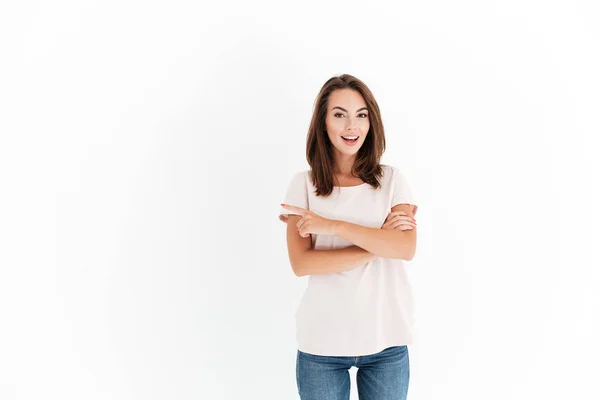 Smiling beauty woman with crossed arms pointing away — Stock Photo, Image