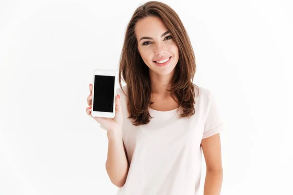 Joyful brunette woman showing blank smartphone screen — Stock Photo, Image