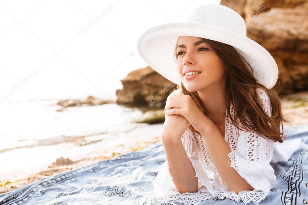 Smiling woman in hat and light summer dress