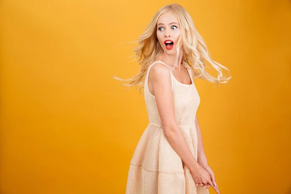 Young blonde woman standing isolated over yellow — Stock Photo, Image