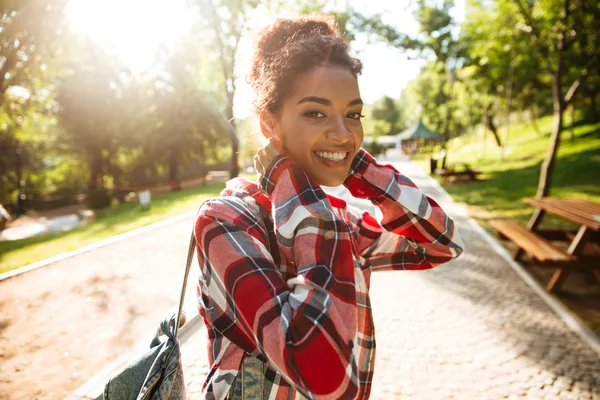 Young african woman walking outdoors in park. Stock Photo