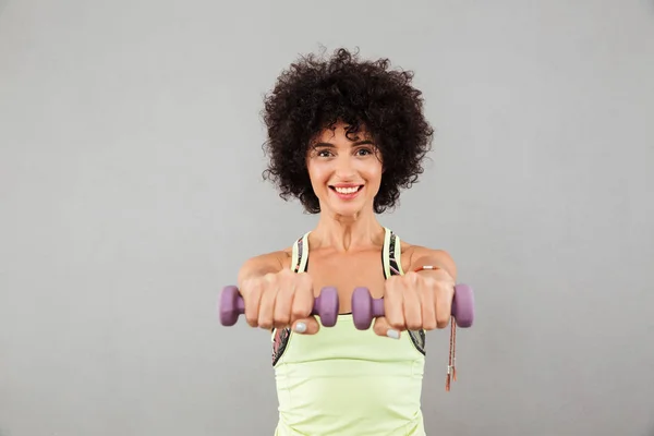 Happy pretty fitness woman doing exercise with dumbbells — Stock Photo, Image