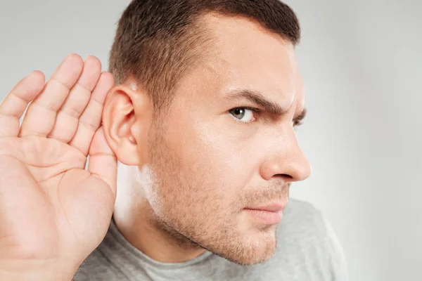 Concentrated man tries to hear you. — Stock Photo, Image