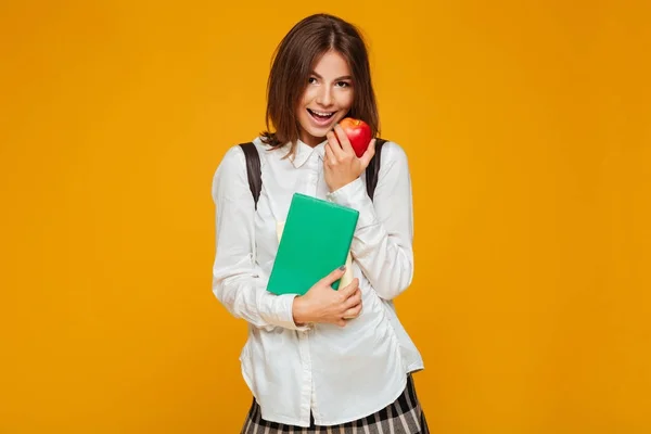 Portrait of a pretty schoolgirl holding books — Stock Photo, Image