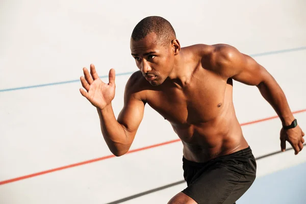 Portrait of a half naked muscular sportsman running — Stock Photo, Image