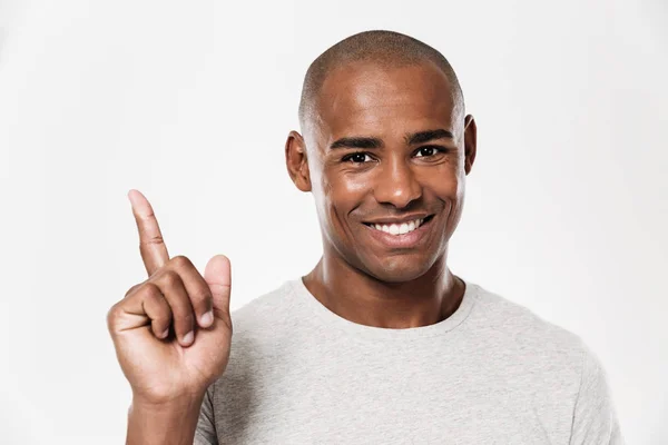 Happy young african man pointing. — Stock Photo, Image