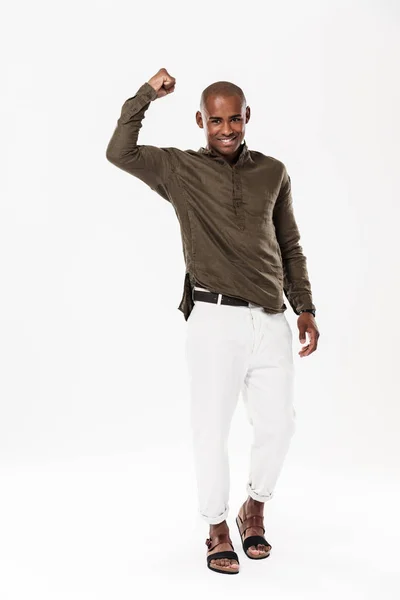 Full length image of Strong african man showing his bicep — Stock Photo, Image