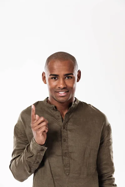 Vertical image of smiling african man pointing up — Stock Photo, Image