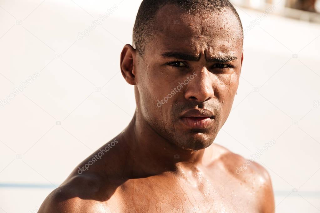 Close-up shot of young african sports man, chilling after runnin