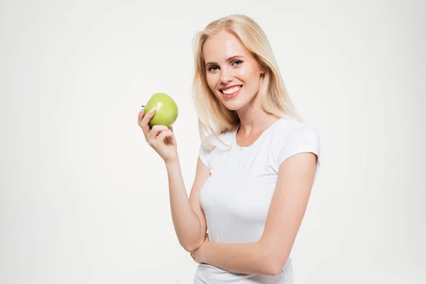 Portrait of a happy fit woman holding green apple — Stock Photo, Image
