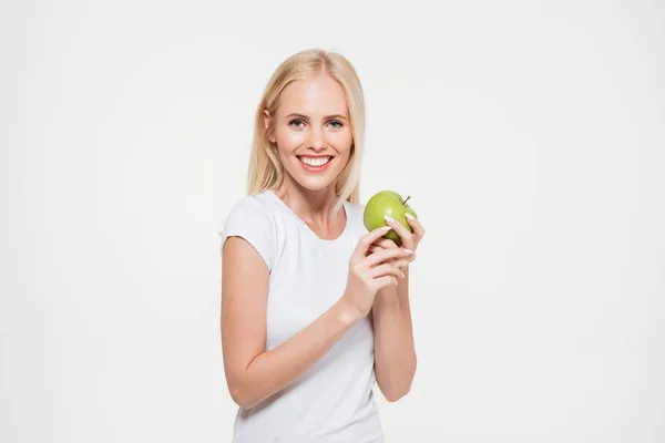 Portrait of a happy healthy woman holding green apple — Stock Photo, Image