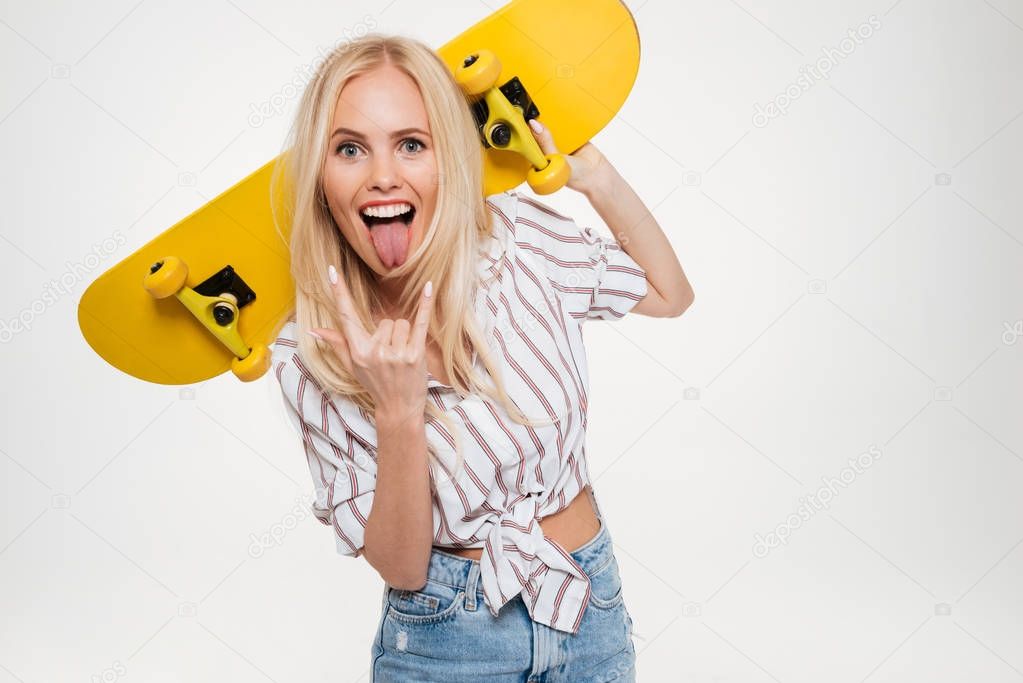 Portrait of a happy crazy woman holding skateboard