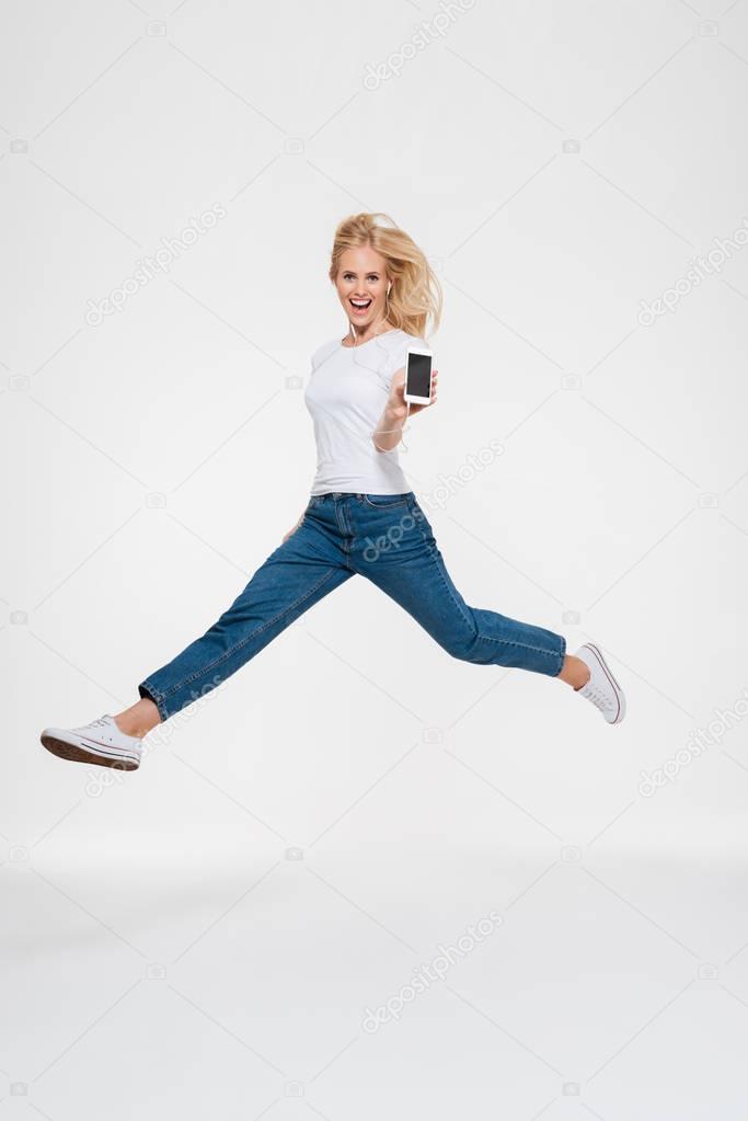 Full length portrait of a happy excited casual blonde woman