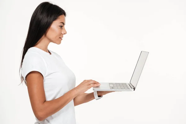 Side view portrait of a young brunette woman working — Stock Photo, Image