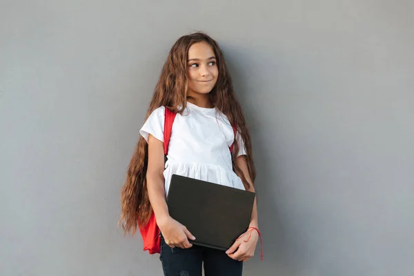 Glimlachend mysterie brunette schoolmeisje met lange haren knuffelen boek — Stockfoto