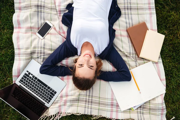 Top view of a smiling young student girl resting