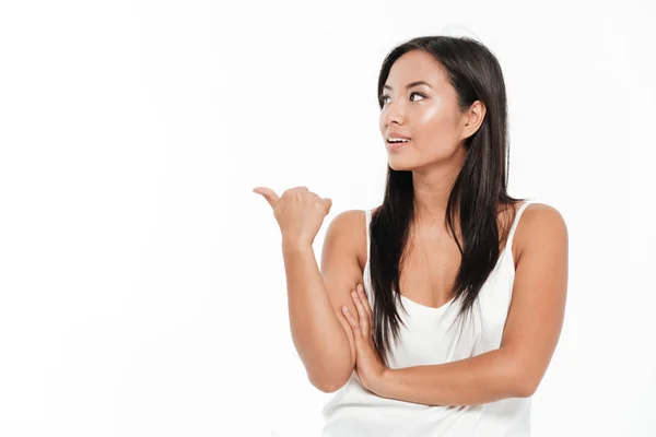 Portrait of an attractive asian woman pointing finger away — Stock Photo, Image