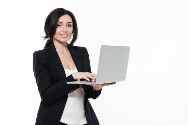 Portrait of a happy smiling businesswoman in a suit typing — Stock Photo, Image