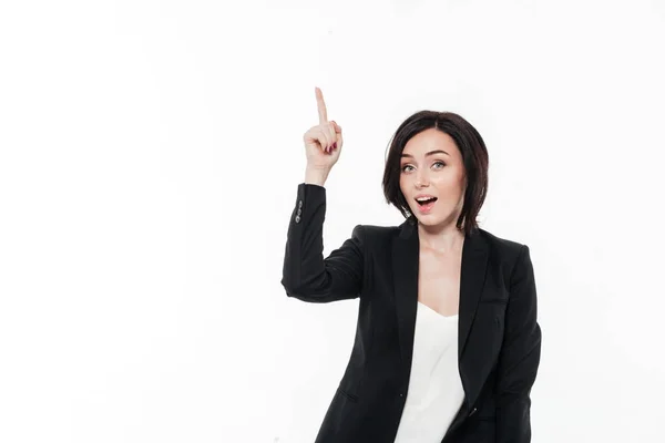 Portrait of an excited pretty businesswoman in a suit pointing — Stock Photo, Image