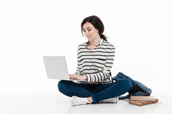 Portrait of a cute teenage girl with backpack typing — Stock Photo, Image