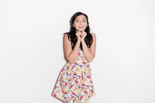 Surprised happy brunette woman in dress looking at the camera — Stock Photo, Image