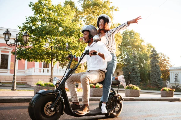 Full length picture of happy african couple rides on motorbike — Stock Photo, Image
